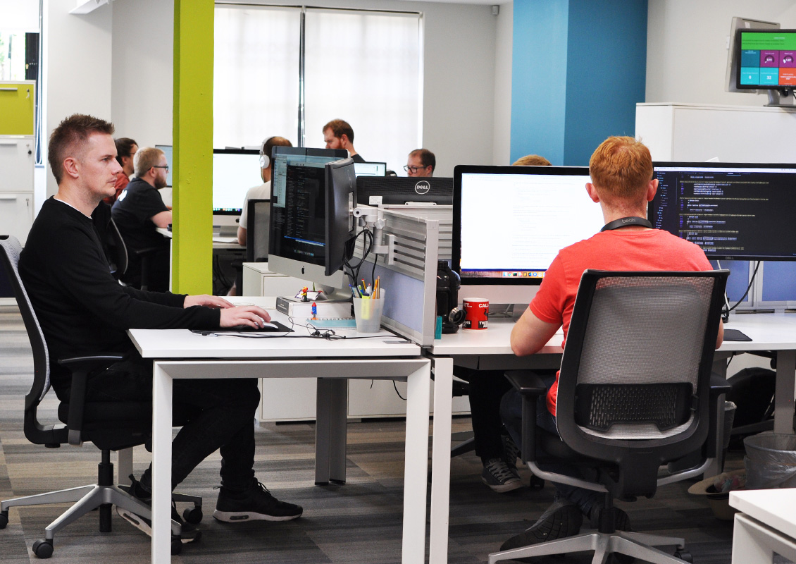 group of developers working at computers in an office